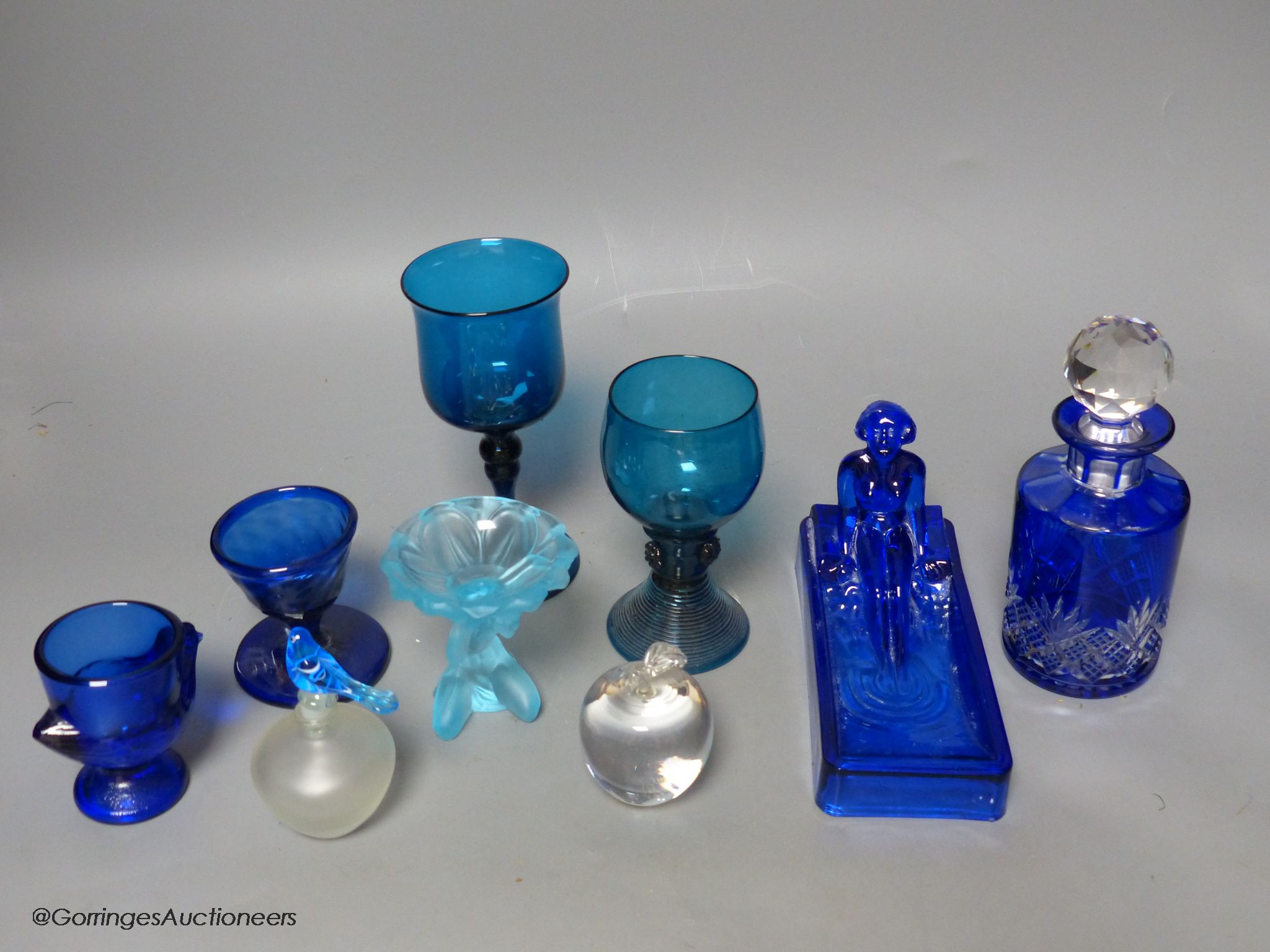 Nine pieces of coloured glassware, including a roemer, a wine glass and a cut glass scent bottle